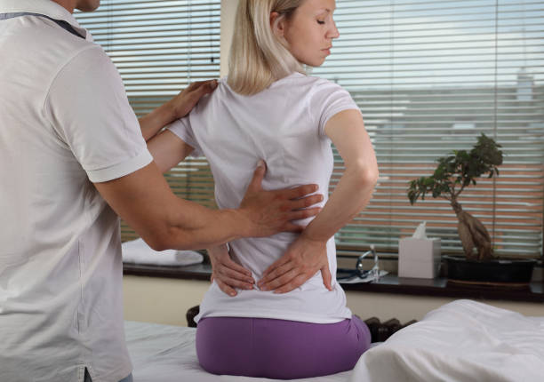 istock Woman having chiropractic back adjustment, healing treatment. Osteopathy, manual therapy, acupressure. Alternative medicine, pain relief concept. Rehabilitation after sport Injury, Physical therapy. 691458020