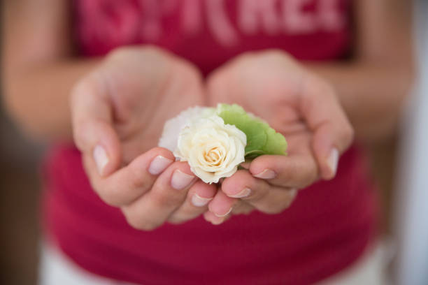 Little girl in dress holding flower in her hands with copy space