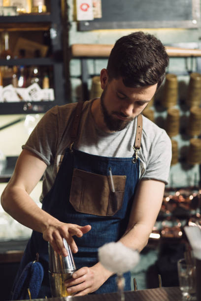 istock Young male bartender preparing an alcohol cocktail 691464130