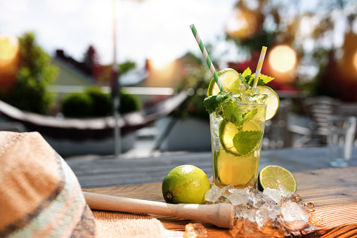 Fresh Mojito cocktail in summer on a terrace with bokeh