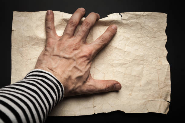 istock Sailor hand catching empty old crumpled paper 691476586