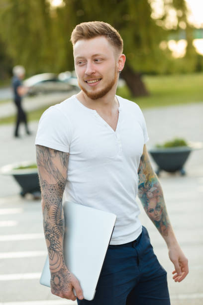 istock Stylish man with laptop outdoors 691487322