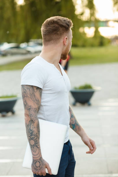 Stylish man with laptop outdoors