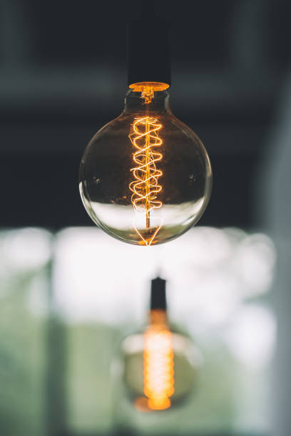 istock vintage edison light bulb hanging with other light bulbs indoors with copy space 691487422
