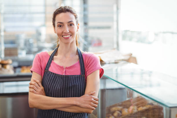 istock Smiling worker looking at camera with arm crossed 691490228
