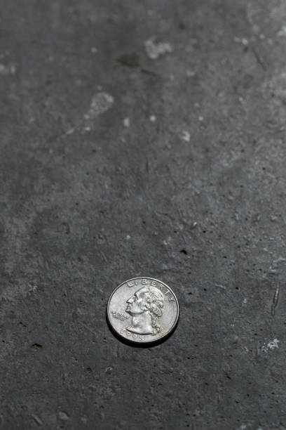 istock American 25 cents coin on the floor. 691493216