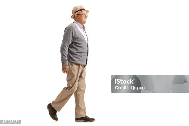 Elderly Man Walking And Smiling Stock Photo - Download Image Now - Walking, White Background, Senior Adult