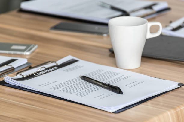 istock smartphones with contract and notebooks with stapler on table at modern office 691497806
