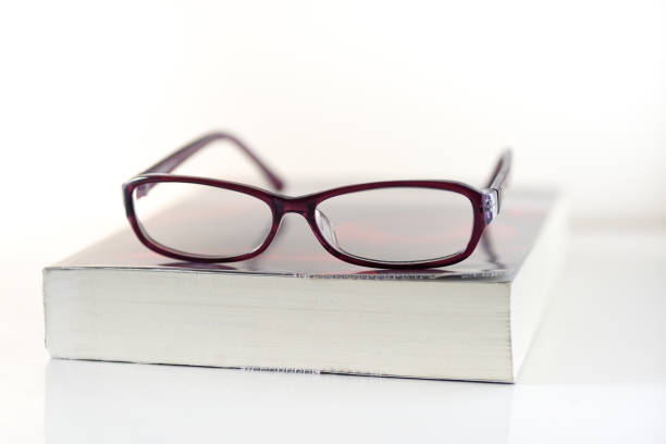 istock Book and glasses on white background 691501098