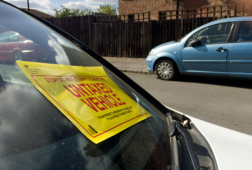 Feltham, UK - December 29, 2016: Notice on the windscreen of an untaxed vehicle parked on a public road