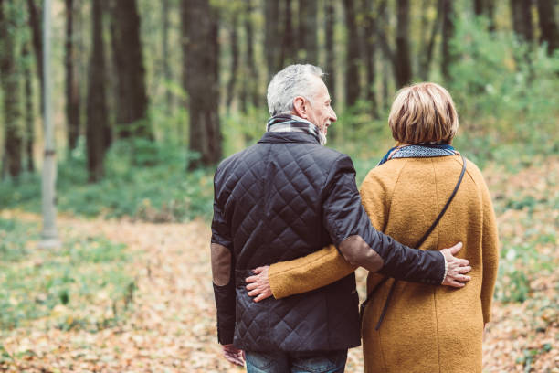 istock Mature couple walking in autumn park 691504568