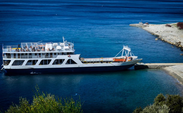 istock Ferry boat arrives at Mount Athos landscape 691510926