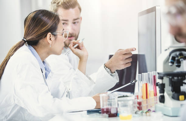 istock Scientists Looking at Computer Monitor and Discussing 691511462