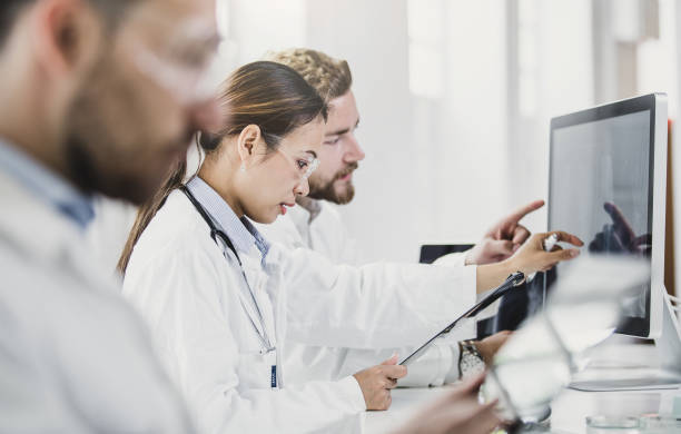istock Scientists Looking at Computer Monitor and Discussing 691511560