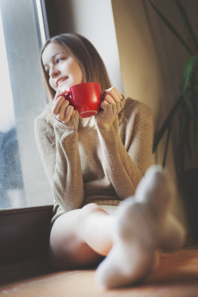 istock Young woman drinking coffe in the morning and using phone 691512106