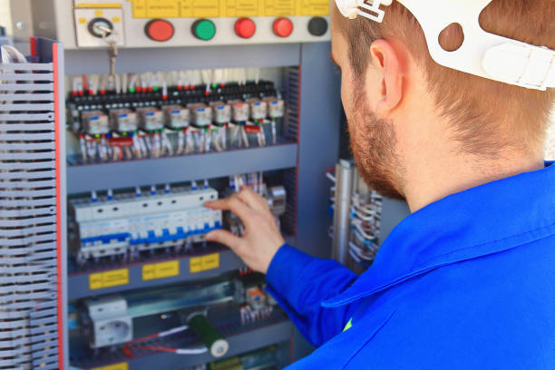 istock Electrical engineer performs switching of industrial equipment on a blurred background of the control cabinet 691519128