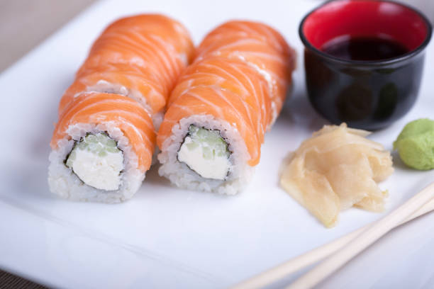 istock Philadelphia sushi roll with red fish on a white plate 691520920