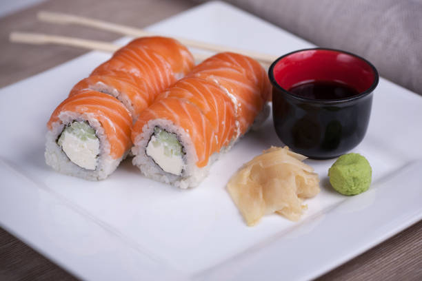 istock Philadelphia sushi roll with red fish on a white plate 691520930