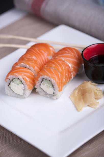 istock Philadelphia sushi roll with red fish on a white plate 691520942