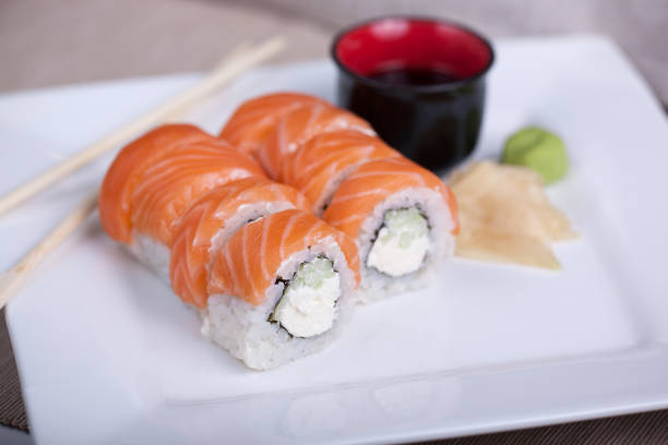 istock Philadelphia sushi roll with red fish on a white plate 691520966