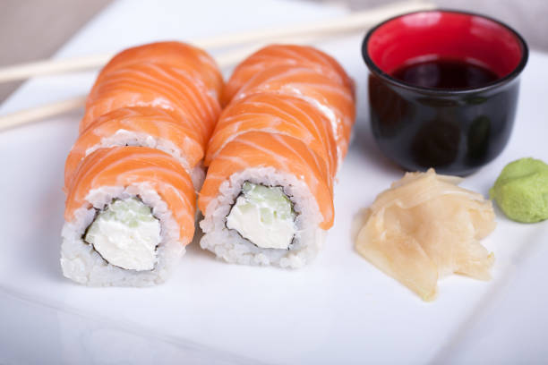 istock Philadelphia sushi roll with red fish on a white plate 691520982