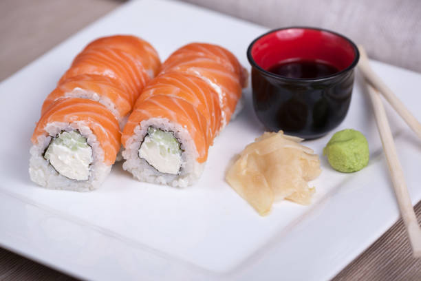 istock Philadelphia sushi roll with red fish on a white plate 691520984