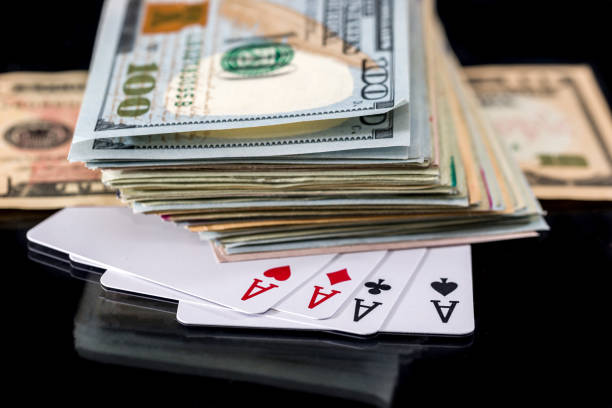 istock four poker aces with dollar isolated on black. 691521340