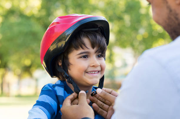 usar casco de ciclo boy - casco de ciclista fotografías e imágenes de stock