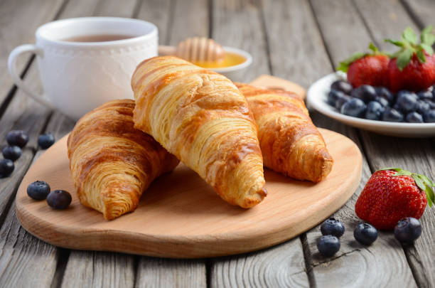 istock Fresh Croissants with fresh berries on rustic wooden background 691523808