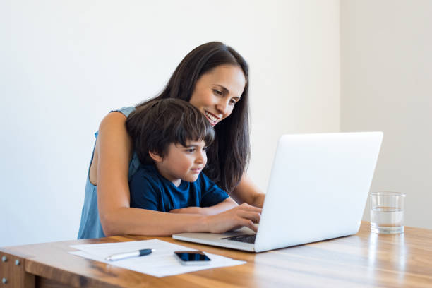 madre che lavora a casa con il figlio - computer child family laptop foto e immagini stock