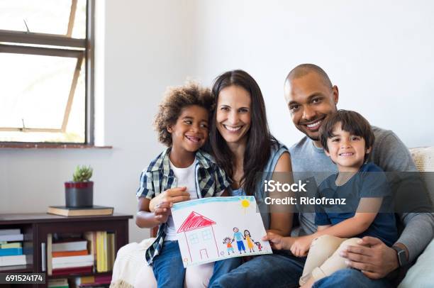 Multiethnic Family On Sofa Stock Photo - Download Image Now - Family, Multiracial Group, Family At Home