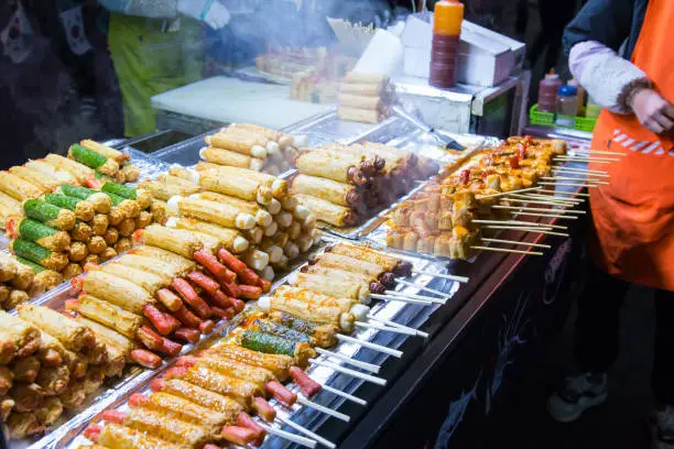Korean street food at Myeong-Dong night market, many meat ball skewers look delicious