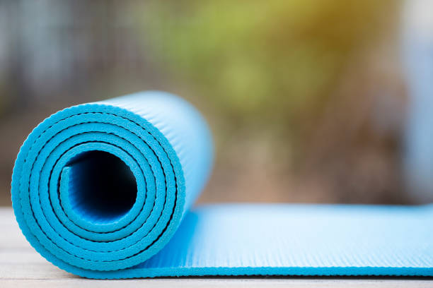 istock blue yoga mat on the wood table background 691527220