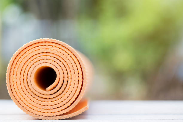 istock yoga mat on the wood table background 691527396