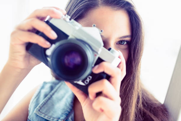 istock Brunette woman taking a photo 691534120