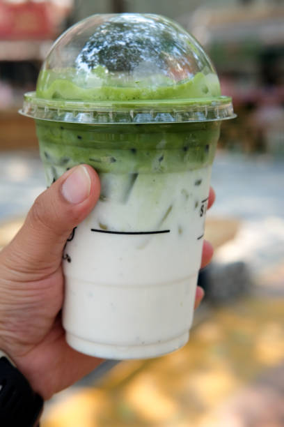 istock Man hand keep iced matcha latte in plastic glass 691537498