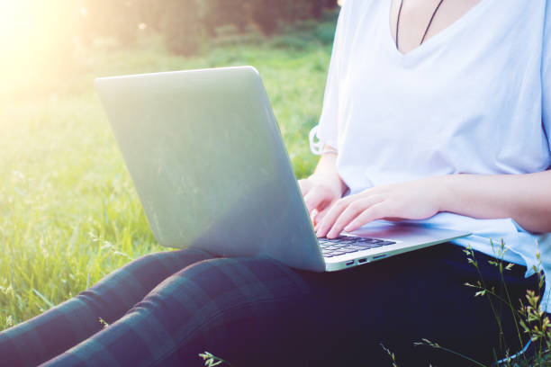 istock woman using laptop outdoors 691537688