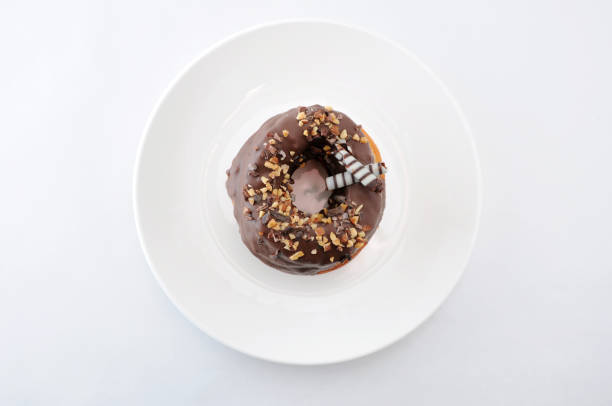 istock sweet chocolate almond cake doughnut on a plate white background 691537720