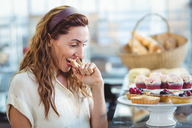 istock Astonished pretty woman looking at cakes 691544282