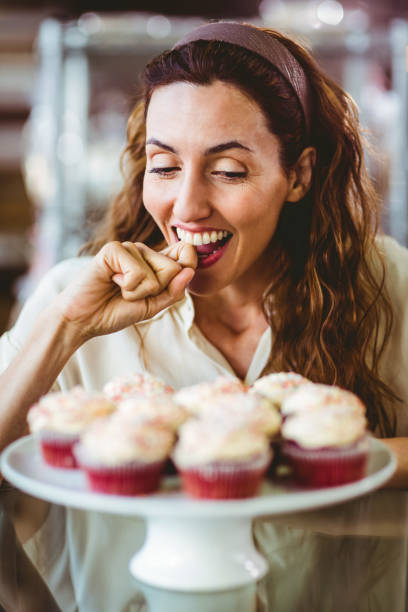 istock Pretty brunette looking at cakes 691547616