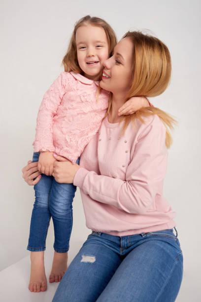 istock Mom and daughter posing in studio 691548542