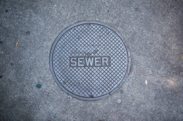 Manhole Cover Iron sidewalk valve cover sewer lid stock pictures, royalty-free photos & images