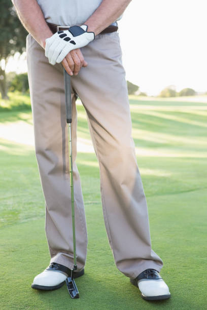 istock Lower half of golfer standing with club 691551592