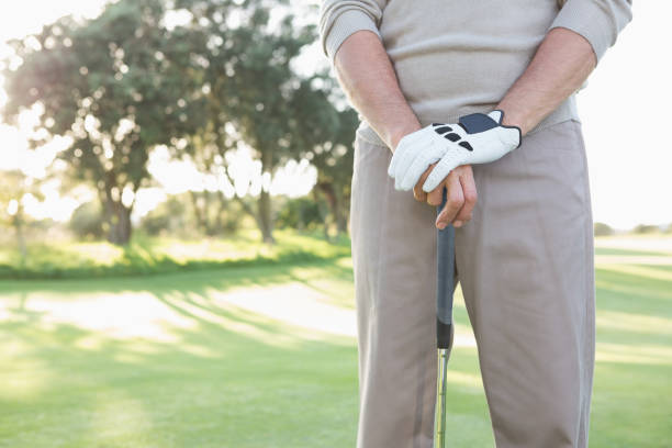 istock Mid section of golfer standing with club 691551616