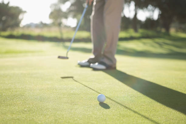 istock Golfer putting ball on the green 691551778
