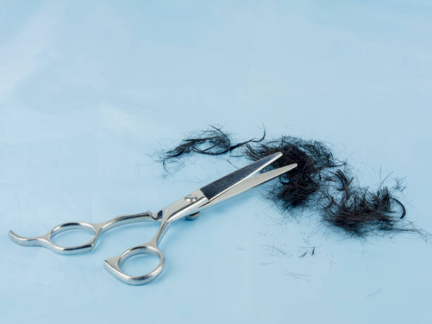 istock Scissors and hairline on blue cloth. 691551816
