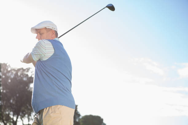 istock Golfer standing and swinging his club 691551960