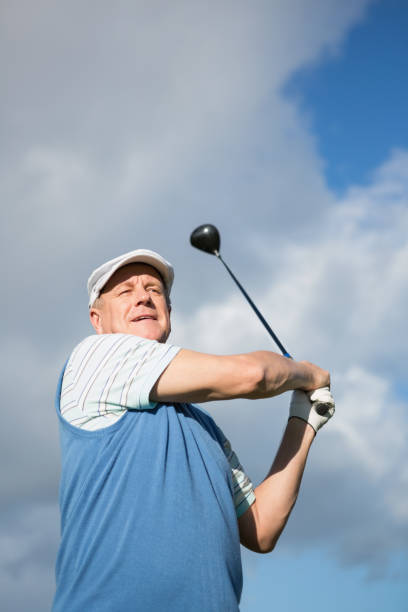 istock Golfer standing and swinging his club 691551978
