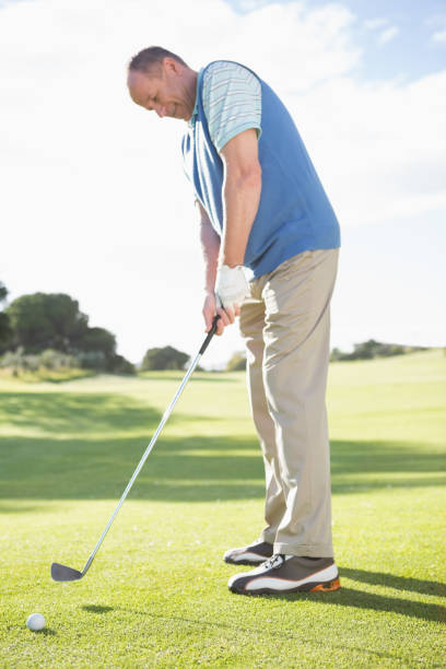 istock Golfer putting ball on the green 691552028