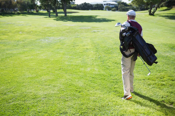 istock Golf player carrying his bag and walking 691554406